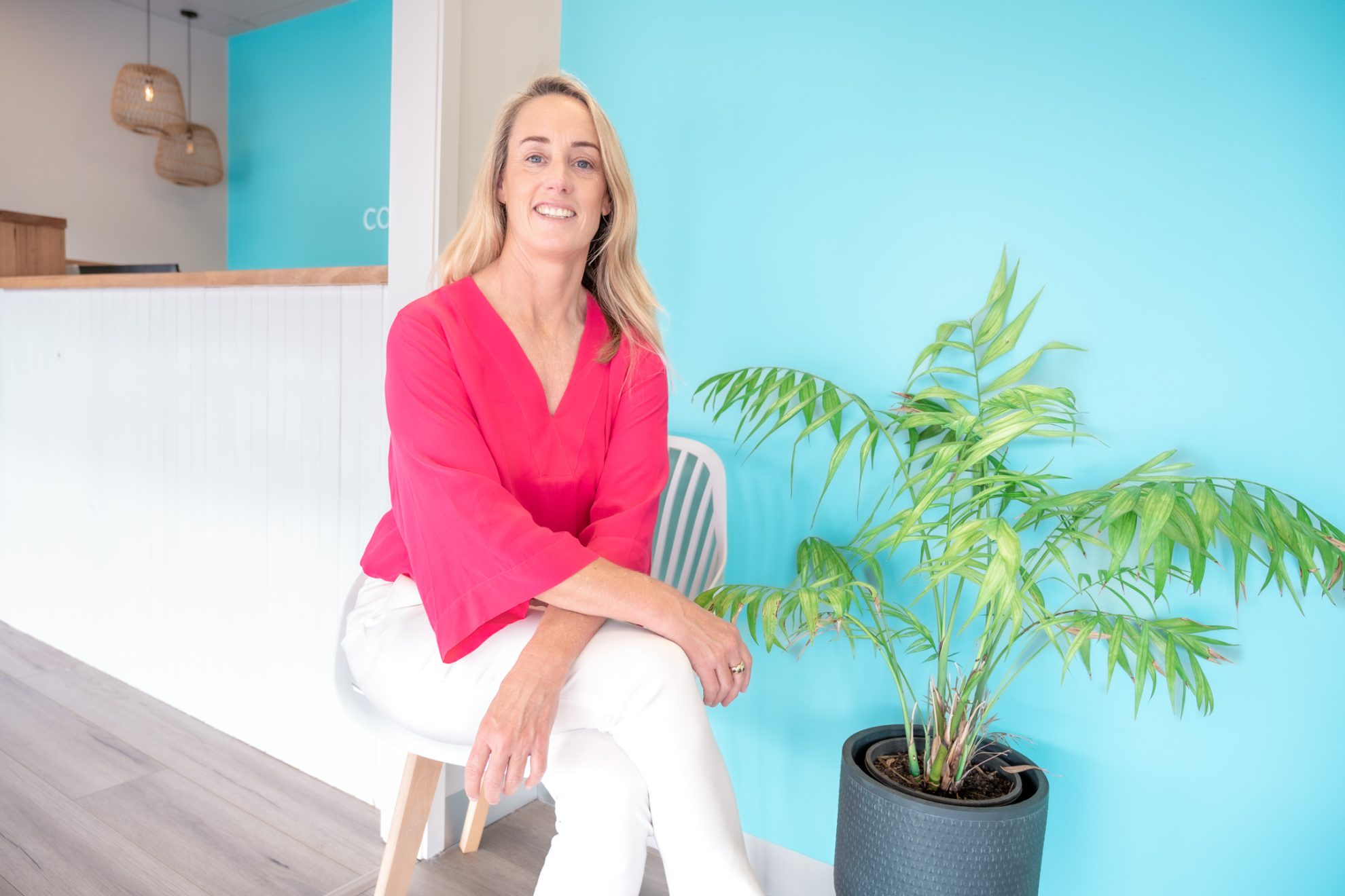 Kate sitting by reception at Coastal Rehab Hub